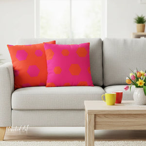 Gray sofa with colorful polka dot pillows and a wooden coffee table with decor items.