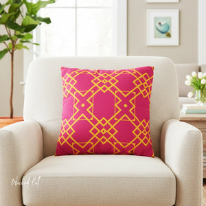 Pink pillow with yellow geometric pattern on a beige armchair in a living room setting.