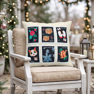 Holiday pillow in a chair with Christmas stamps on the front