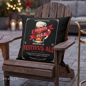 A black decorative throw pillow featuring a vintage-style beer label design for 'North Pole Festivus Ale' by Wicked Cat, displayed on a wooden Adirondack chair in an outdoor patio setting.