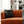Black bat pillow on an orange couch in a living room setting