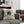 Decorative pillow with Bates Motel design on a gray couch in a Halloween-themed room.