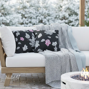 White outdoor sofa with floral cushions and a blanket, set against a snowy background.