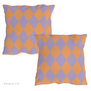 Two diamond-patterned pillows in purple and orange on a white background, with 'Wicked Cat' branding.