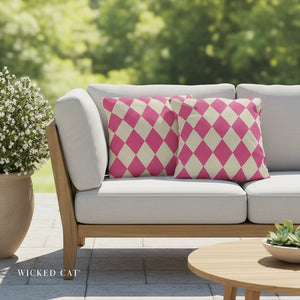 Outdoor sofa with pink and white patterned cushions, surrounded by greenery.