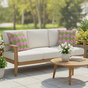 Outdoor patio set with a sofa, coffee table, and decorative pillows on a sunny day.