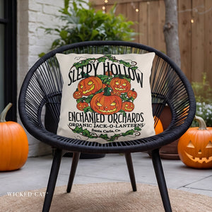 Decorative pillow with Halloween design on a black wicker chair outdoors.