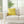 Yellow pillow with black design on a beige sofa in a bright living room.