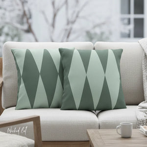 Gray sofa with green geometric patterned cushions in a blurred outdoor setting