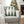 Gray sofa with a green and white geometric pillow, Christmas tree in the background