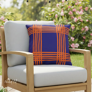 Chair with white cushion and blue and orange checkered pillow in outdoor setting