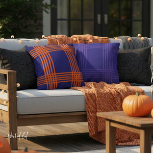 Outdoor seating area with Halloween-themed pillows and a pumpkin on a wooden table.