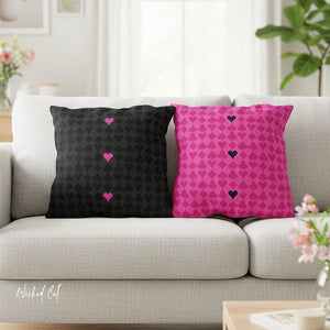 Black and pink patterned pillows on a gray sofa with 'Wicked Cat' branding.