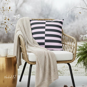 Chair with a striped pillow and blanket in a snowy outdoor setting
