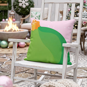 A decorative throw pillow shaped like a Christmas stocking sits on a white rocking chair in a cozy outdoor patio setting with a fire pit and holiday decorations in the background.