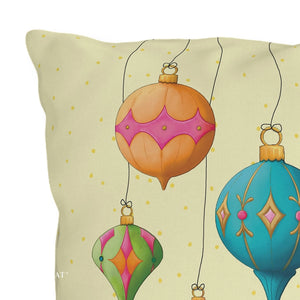 A square decorative throw pillow featuring a whimsical illustration of colorful hanging ornaments on a pale cream background with small gold polka dots.