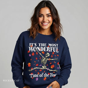 Woman wearing a navy blue sweatshirt with a skeleton design and text on a gray background