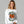 Woman wearing a white sweatshirt with 'Sleepy Hollow Enchanted Orchards' design on a gray background