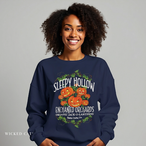 Person wearing a navy blue sweatshirt with 'Sleepy Hollow Enchanted Orchards' design on a gray background