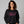 woman wearing black sweatshirt with pink embroidered text 'unapologetically difficult'