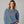 woman wearing blue sweatshirt with embroidered pink text 'unapologetically difficult'