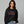 Woman wearing black sweatshirt that reads Festivus tis the season to air your grievances.