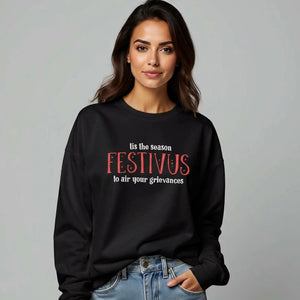Woman wearing black sweatshirt that reads Festivus tis the season to air your grievances.