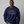 Man wearing navy blue sweatshirt that reads Festivus tis the season to air your grievances.
