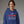 Woman wearing a blue hoodie with Festivus text on a gray background