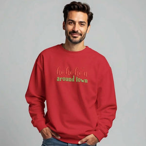 Man wearing a red sweatshirt that reads ho ho ho'n around town in red and green text.