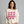 Woman wearing a white sweatshirt with pink text on a gray background