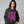 Person wearing a black sweatshirt with pink text on a gray background