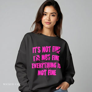 Person wearing a black sweatshirt with pink text on a gray background