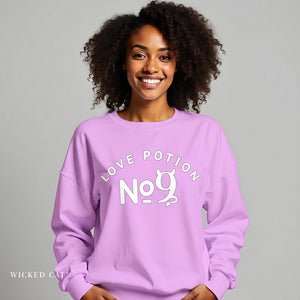 Woman wearing a purple sweatshirt with 'Love Potion No. 9' text on a gray background