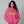 Woman wearing a pink hoodie with a colorful text design on a gray background