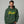 Man wearing a green hoodie with text on a gray background