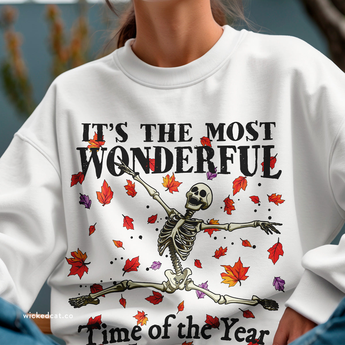 Yellow Halloween sweatshirt with skeleton design and text 'It's the most wonderful time of the year' on a white background