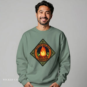 Man wearing a green sweatshirt with a graphic design on a gray background