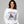 Woman wearing a white sweatshirt with a motorcycle and witch graphic, text 'Midnight Coven' on a gray background.
