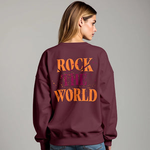 Woman facing the back wearing a maroon sweatshirt that says Rock the World