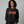 Woman wearing a black sweatshirt that says Start Jumping