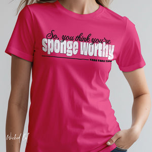 Person wearing a dark gray t-shirt with 'Sponge Worthy 90s Seinfeld Grunge' design on a plain background