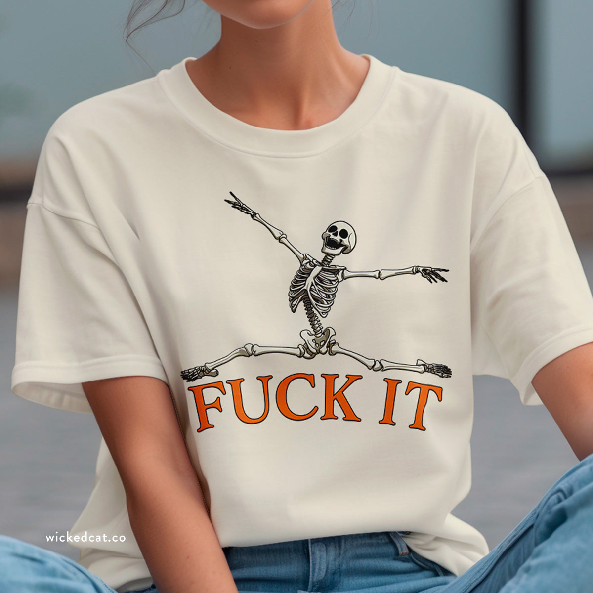 Purple t-shirt with a skeleton graphic and 'FUCK IT' text on a white background