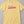 Yellow t-shirt with embroidered text that says Pass the Potatoes 