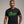 Person wearing a Dark Grey t-shirt with 'Get Lucky Funny St. Patrick's Party' design on a plain background