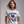 Woman wearing a white patriotic t-shirt with 'Kicking Kings to the curb since 1776' graphic and text.
