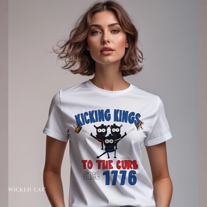 Woman wearing a white patriotic t-shirt with 'Kicking Kings to the curb since 1776' graphic and text.