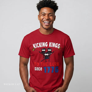 Man wearing a red patriotic t-shirt with 'Kicking Kings to the curb since 1776' graphic and text.