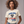 Woman wearing a white patriotic t-shirt with 'Kicking Kings to the curb since 1776' graphic and text.