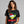 Woman wearing a black t-shirt with a Christmas margarita graphic and text.